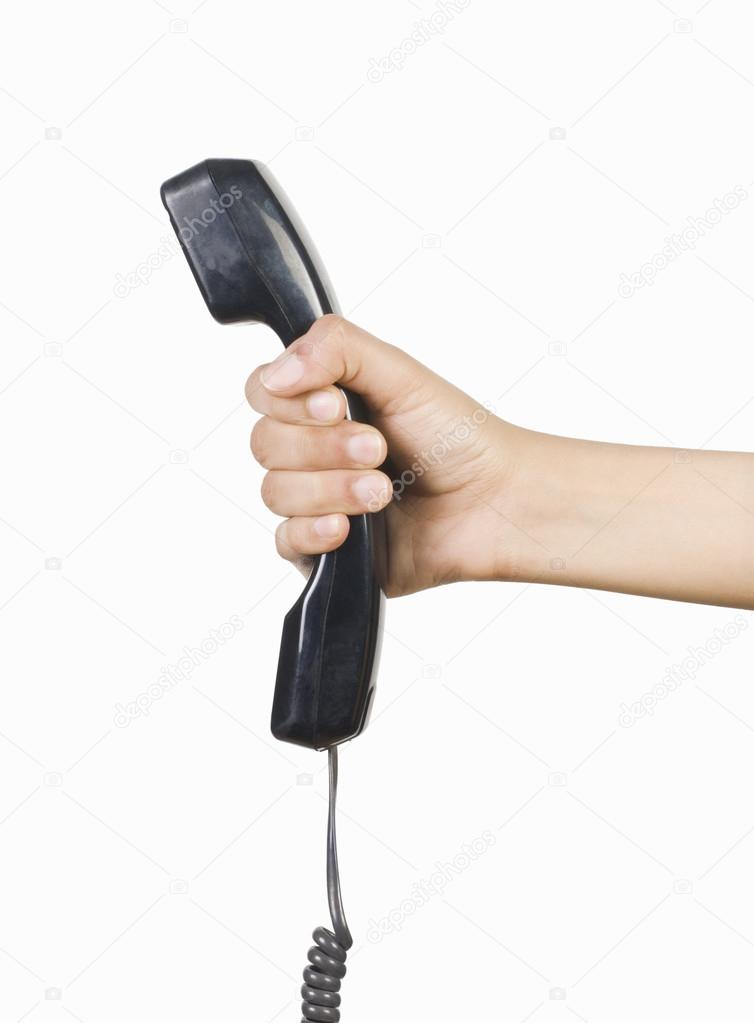 Hand holding a telephone receiver