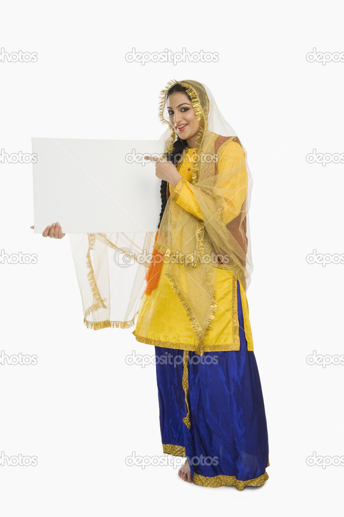 Woman in Punjabi dress holding a placard