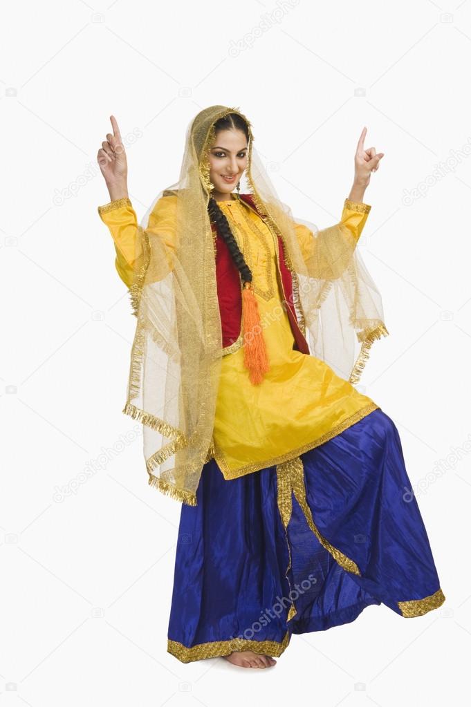Woman in Punjabi dress doing bhangra