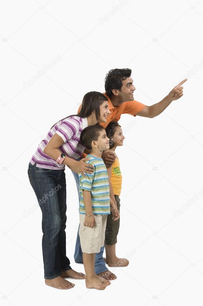 Parents with their children and pointing