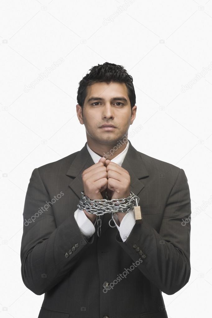 Businessman locked with chains