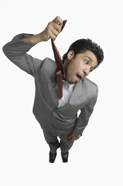 Businessman hanging himself with his tie — Stock Photo, Image
