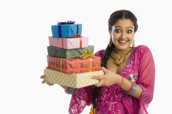 Woman in traditional dress holding gifts — Stock Photo, Image