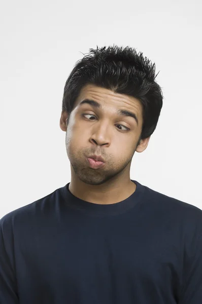 Man making a face with puffed cheeks — Stock Photo, Image