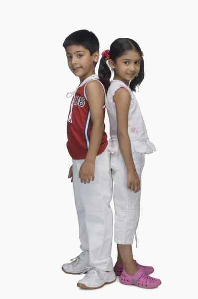 Children standing back to back — Stock Photo, Image