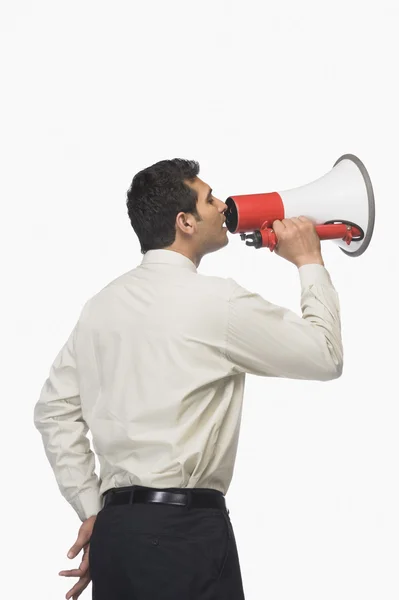 Businessman announcing into a megaphone — Stock Photo, Image