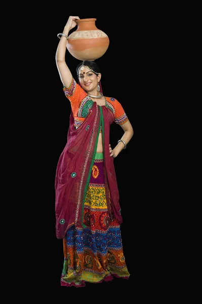 Woman in lehenga choli carrying water pot — Stock Photo, Image