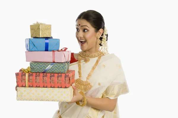 Woman holding gifts — Stock Photo, Image