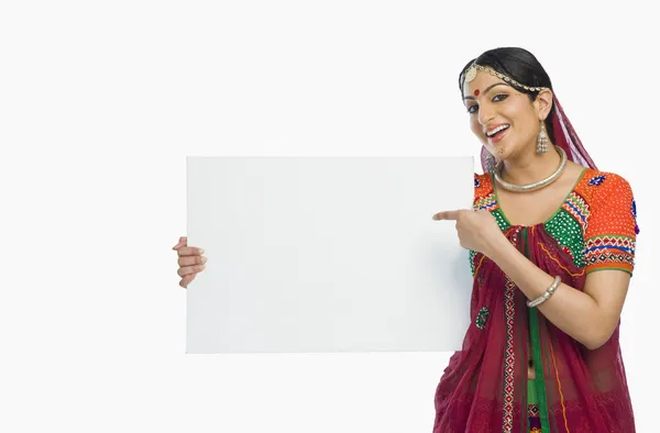 Kvinna i lehenga choli håller ett plakat — Stockfoto