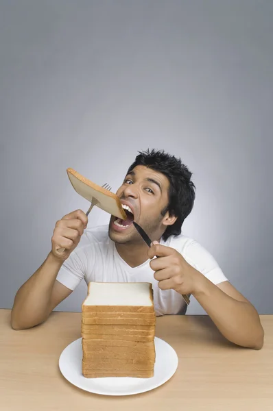 Mann isst ein Stück Brot — Stockfoto