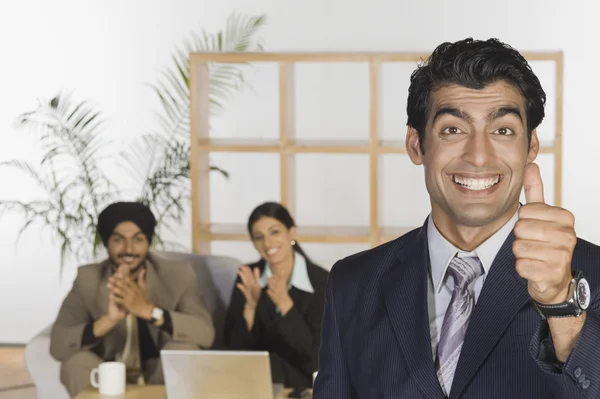 Businessman showing thumbs up sign — Stock Photo, Image