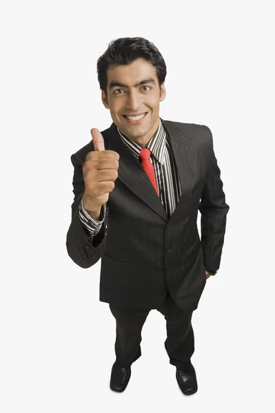 Businessman showing thumbs up sign — Stock Photo, Image