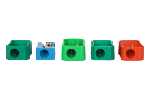 Assorted colorful pencil sharpeners in a row — Stock Photo, Image