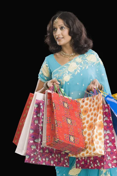 Woman carrying shopping bags — Stock Photo, Image