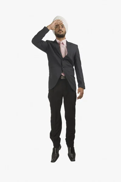 Businessman with shielding his eyes — Stock Photo, Image