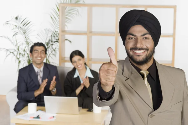 Businessman showing thumbs up sign — Stock Photo, Image