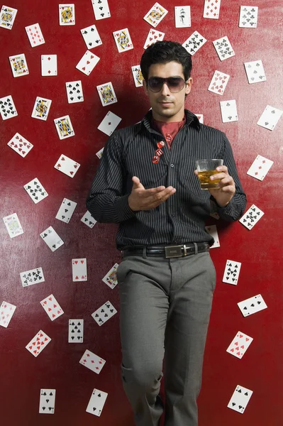 Man drinking whiskey and tossing dices — Stock Photo, Image