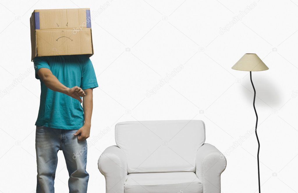 Man covering his face in a cardboard box