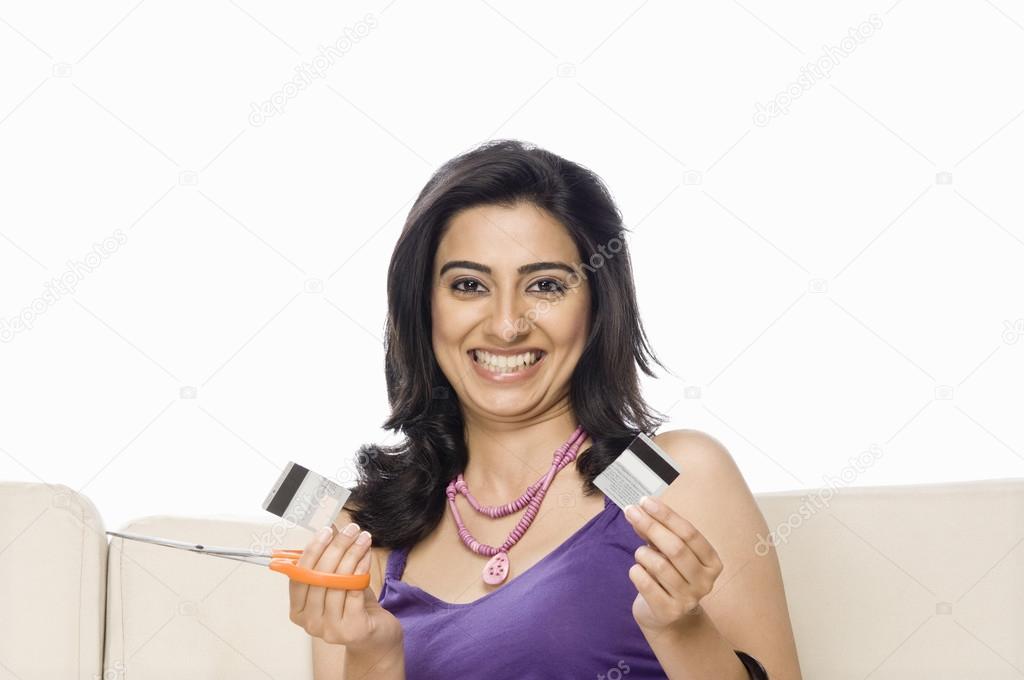 Woman cutting her credit card