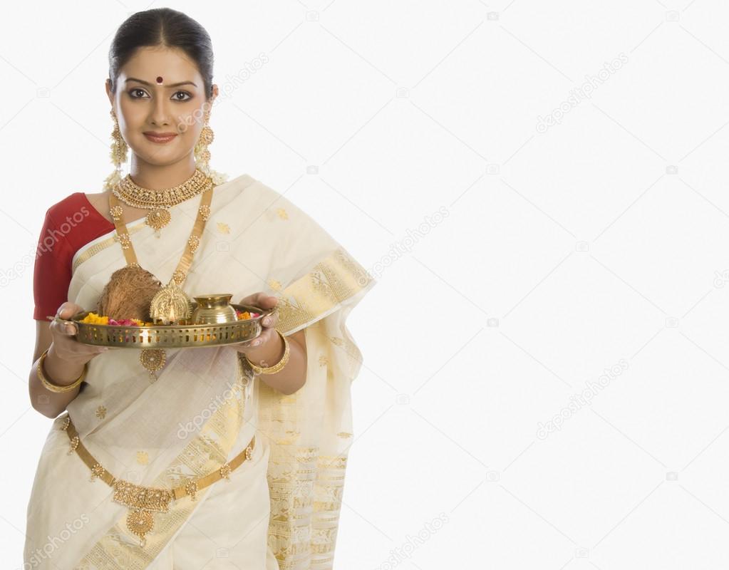 Woman holding a plate of religious offerings