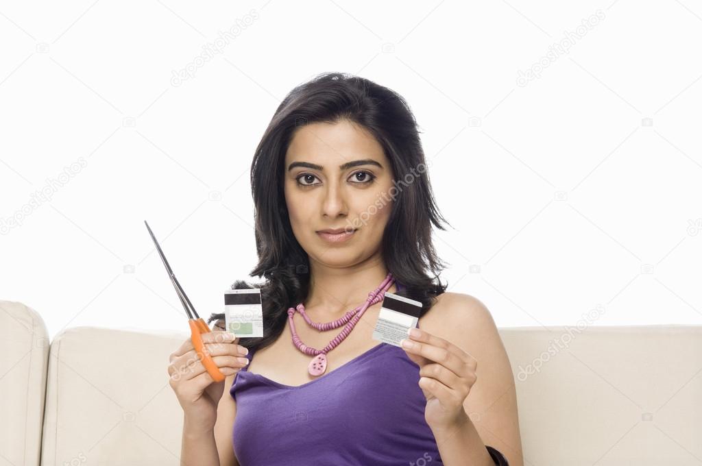 Woman cutting her credit card