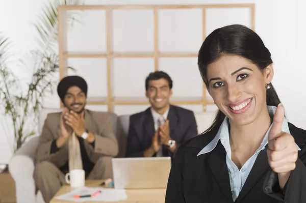 Business executives showing thumbs up sign — Stock Photo, Image