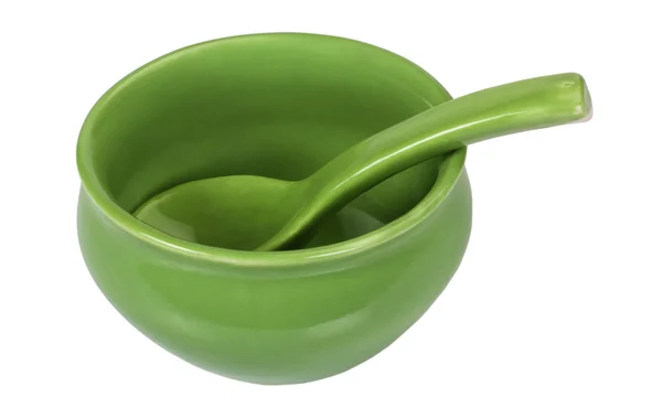 Close-up of a ceramic bowl with a soup spoon — Stock Photo, Image