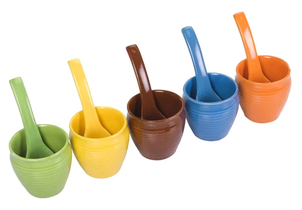 Assorted ceramic containers and soup spoons — Stock Photo, Image