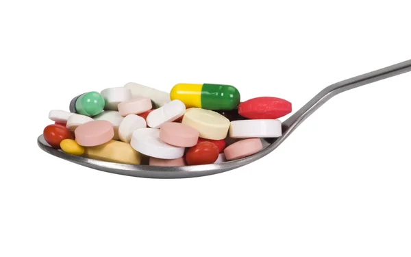 Close-up of a spoon full of pills — Stock Photo, Image