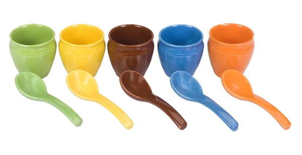 Assorted ceramic containers and soup spoons — Stock Photo, Image