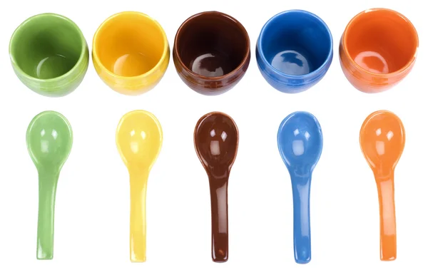 Assorted ceramic containers and soup spoons — Stock Photo, Image