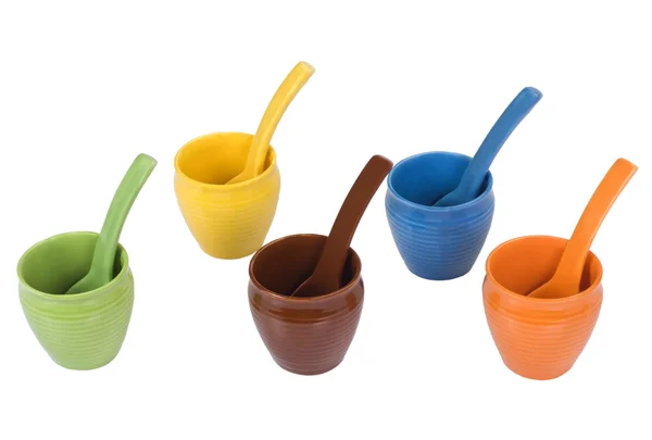 Assorted ceramic containers and soup spoons — Stock Photo, Image