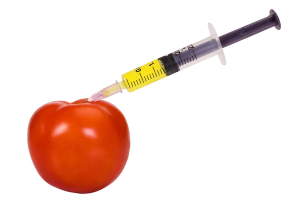 Tomato being injected with a syringe — Stock Photo, Image