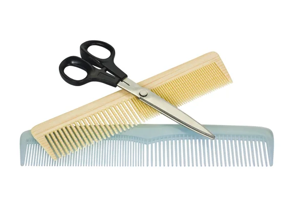 Close-up of two combs with scissors — Stock Photo, Image