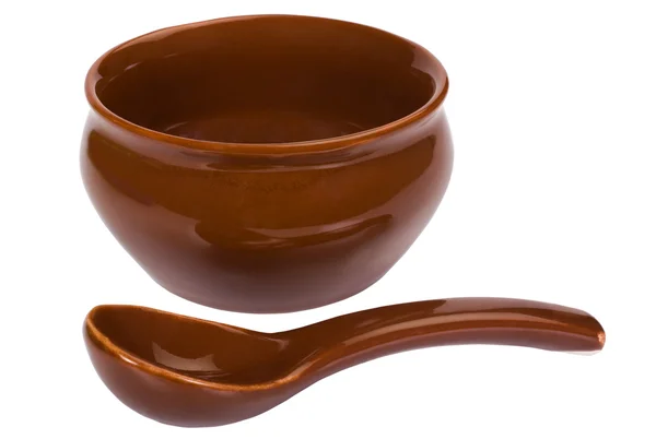 Närbild av en keramik skål med soppa sked — Stockfoto