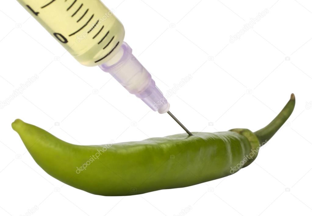 Green bell pepper injected with a syringe