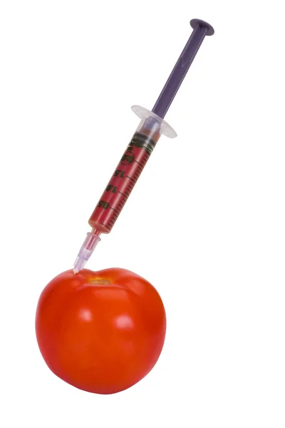 Tomato being injected with a syringe — Stock Photo, Image