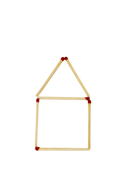 Close-up of house shape made of matchsticks — Stock Photo, Image