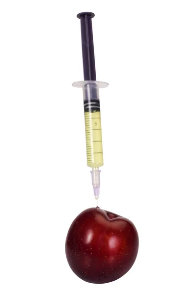 Syringe being injected into a plum — Stock Photo, Image