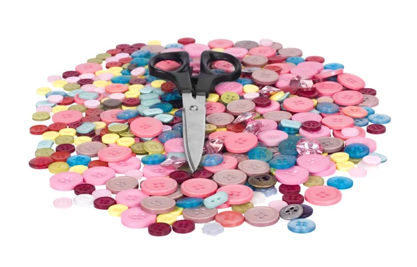 Scissors on a heap of buttons — Stock Photo, Image