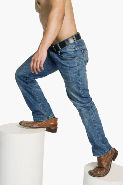 Hombre en jeans subiendo escalones — Foto de Stock