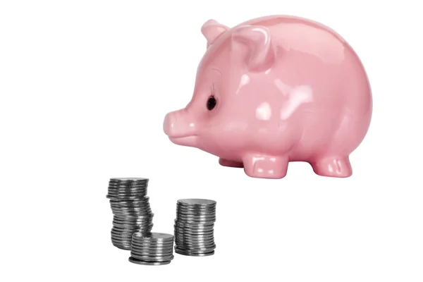 Close-up of a piggy bank and a stacks of coins — Stock Photo, Image