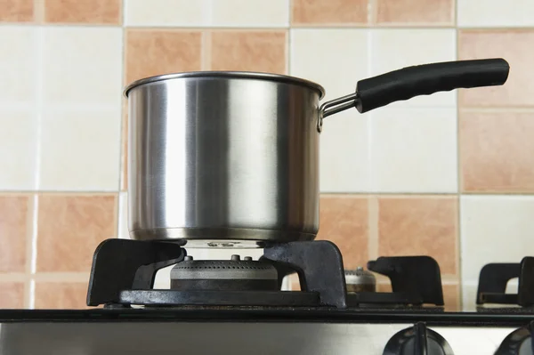 Saucepan on a stove — Stock Photo, Image