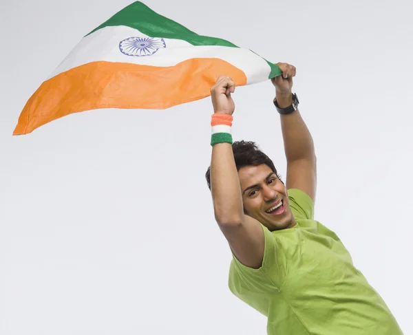 Man holding aloft an Indian flag — Stock Photo, Image