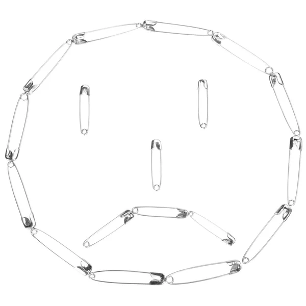 Cara triste hecha de alfileres de seguridad —  Fotos de Stock
