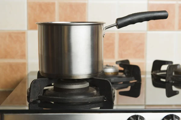 Saucepan on a stove — Stock Photo, Image