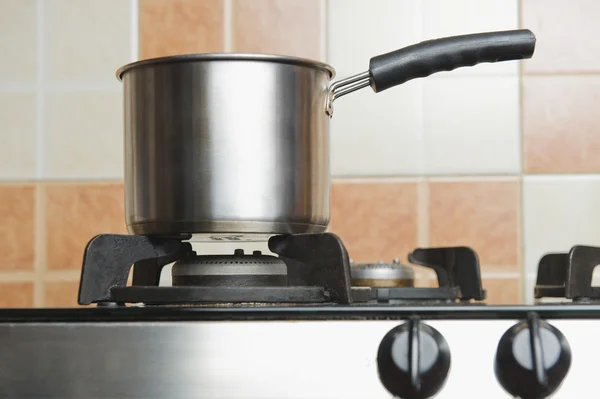 Saucepan on a stove — Stock Photo, Image