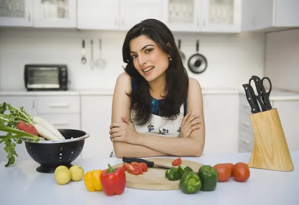 Woman leaning on a kitchen counter — Stock Photo, Image