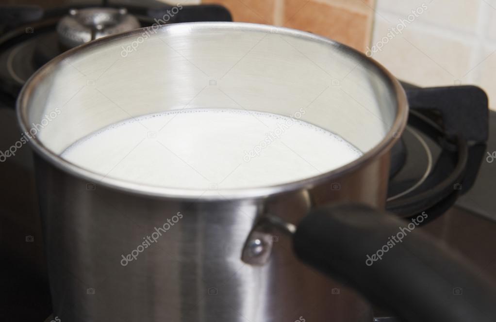 Milk in a saucepan on a gas stove burner
