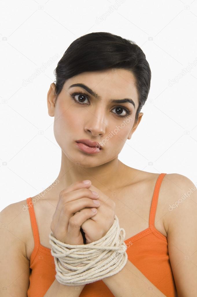 Woman's hands tied with a rope